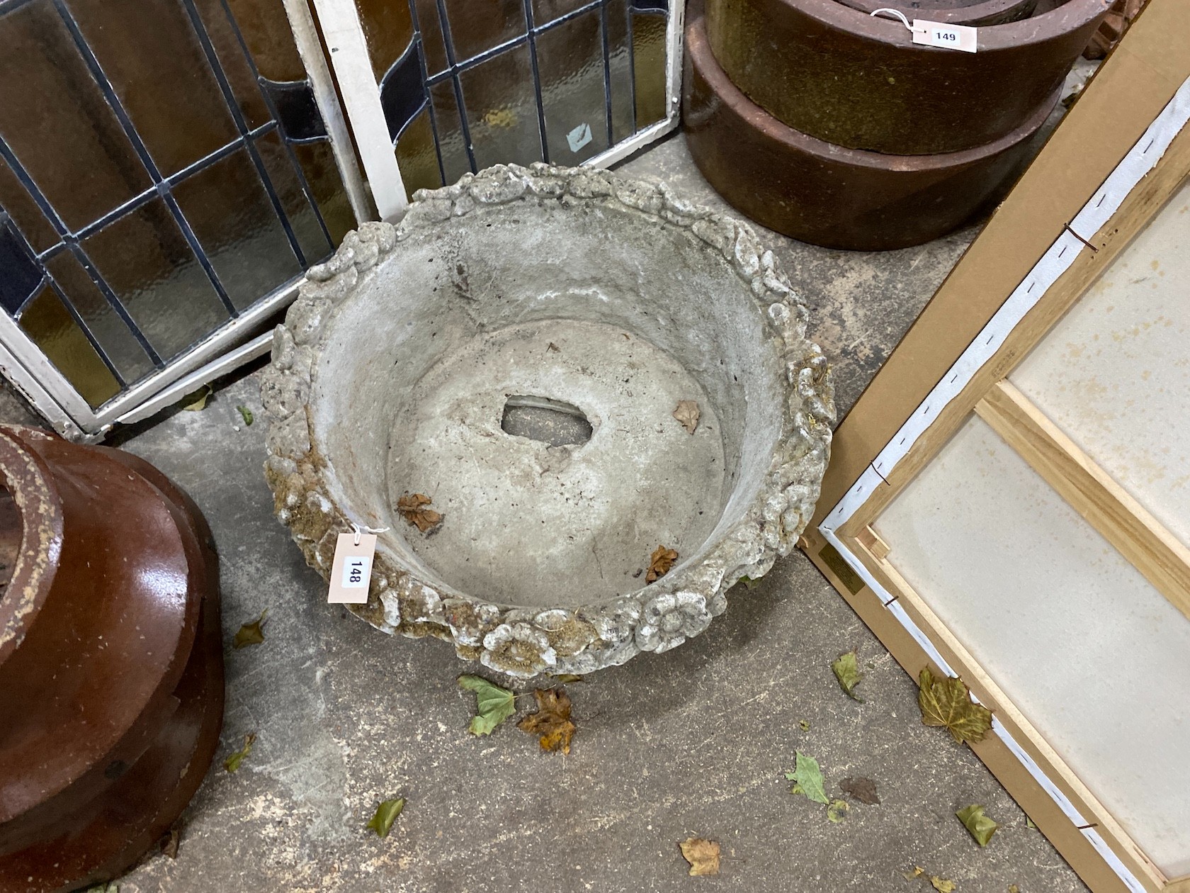 A circular reconstituted stone basket weave garden planter with floral rim, diameter 60cm, height 23cm